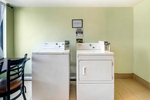 a room with two refrigerators and a table at Comfort Suites Wilmington near Downtown in Wilmington