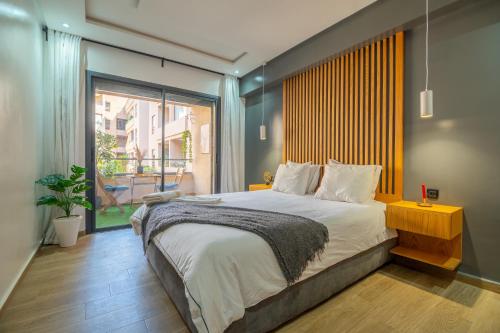 een slaapkamer met een groot bed en een groot raam bij Royal KING Bed SUITE W/POOL in Marrakesh