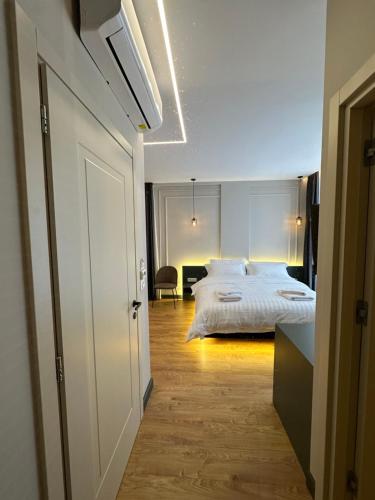 a bedroom with a white bed and a desk at Tirana Central Rooms in Tirana