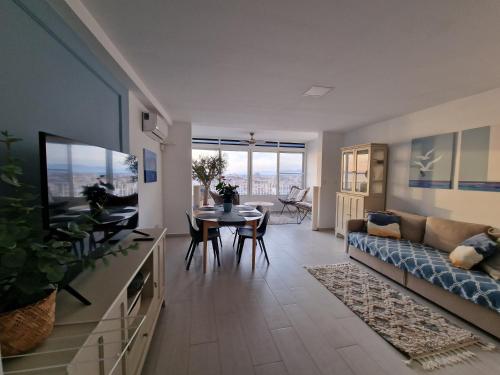 a living room with a couch and a table at Sunset 8F in Santa Pola