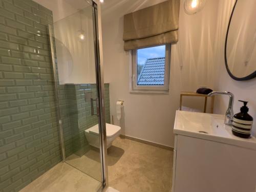 a bathroom with a toilet and a glass shower at Słoneczny Stok in Małastów