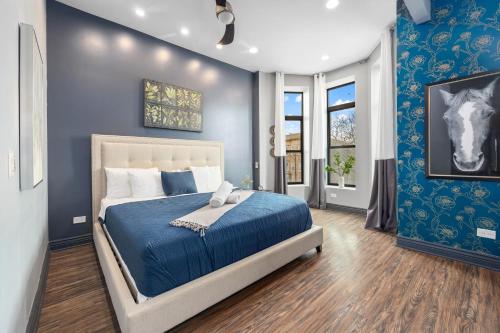 a bedroom with a bed with blue walls at McCormick Place Guest House in Chicago