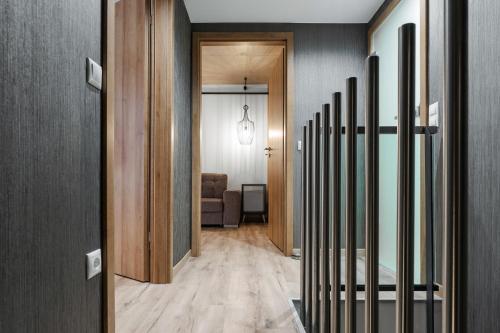a hallway leading to a living room with wood floors at Onyx Luxury Budapest in Budapest