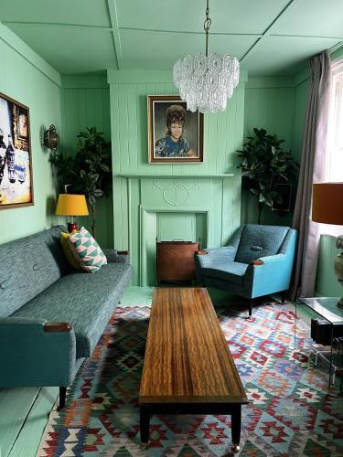a living room with a couch and a table at Georgian Russell in Hastings