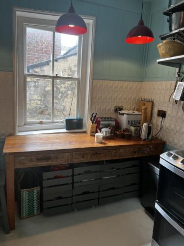a kitchen with a wooden counter with a window at Georgian Russell in Hastings