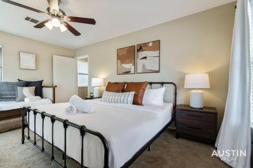 a bedroom with two beds and a ceiling fan at Walk to Zilker Patio w a View Elevated Balcony in Austin