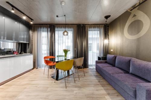 a living room with a purple couch and a table at Onyx Luxury Budapest in Budapest