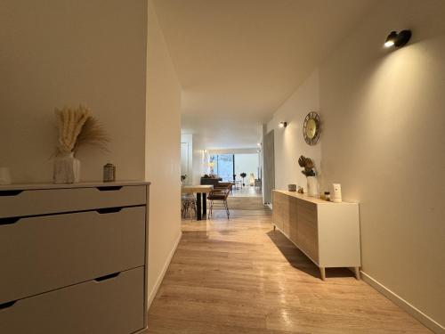 a living room with a dresser and a hallway at Le Repère des Pilotes - Gare - 11p - Rêve au Mans in Écommoy