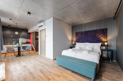 a bedroom with a large bed and a kitchen at Onyx Luxury Budapest in Budapest