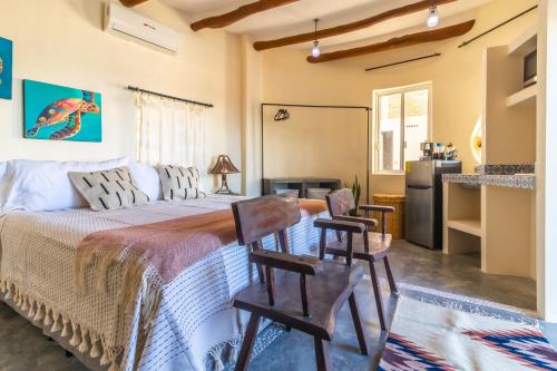 a bedroom with a bed and chairs in a room at Pacific Villa Punta Mita-Playa Careyeros in Punta Mita