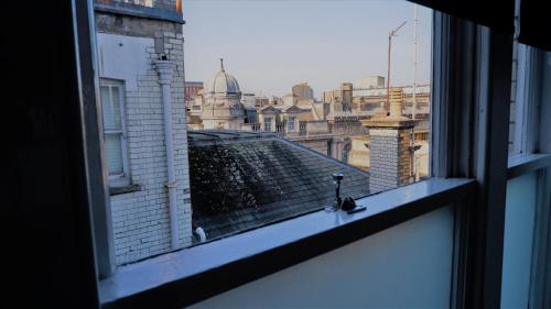 a view of a city from a window at Ideal location! Studio flat in heart of the city in Bristol