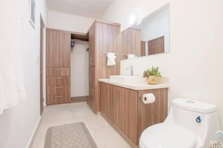 a bathroom with a toilet and a sink at Spacious home with private yard and community pool in La Paz