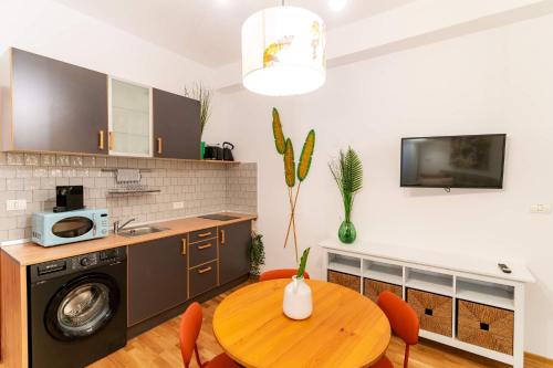 a kitchen with a wooden table and a dining room at Rezident in Bucharest