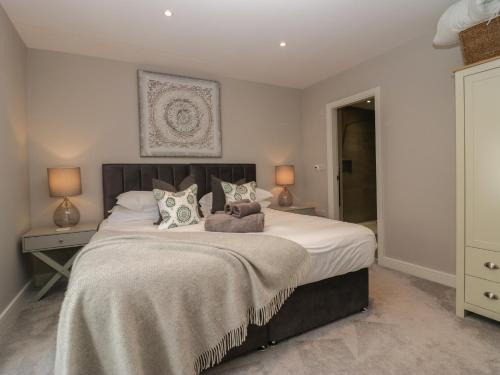 a bedroom with a large bed and two lamps at Helton Fell in Kendal