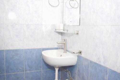 a bathroom with a sink and a mirror on the wall at Fully furnished two bedroom bnb in Thika town in Thika