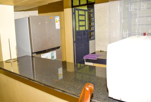 a glass counter in a room with a refrigerator at Fully furnished two bedroom bnb in Thika town in Thika
