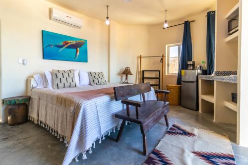 a bedroom with a bed and a table and a refrigerator at Pacific Villa Punta Mita-Playa Careyeros in Punta Mita