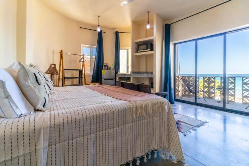 a bedroom with a bed and a large window at Pacific Villa Punta Mita-Playa Careyeros in Punta Mita