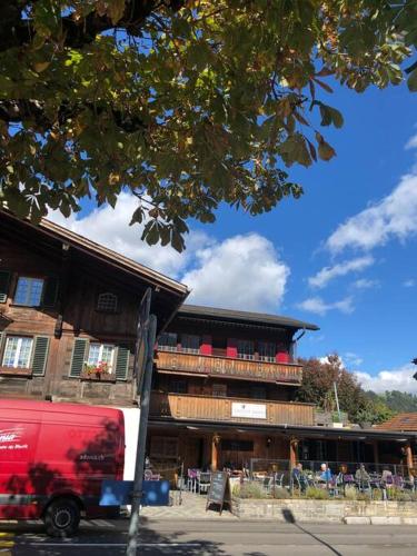 a red van parked in front of a building at Region de Gstaad - Ultra Modern Apartment- Huge Roof Terrace - Great Views in Zweisimmen