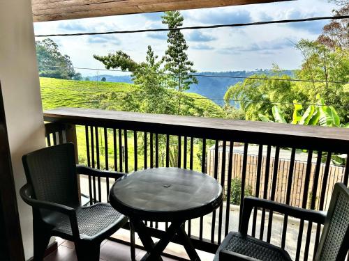 a table and two chairs on a balcony with a view at Villa Salento Boutique Apartments & Spa in Salento