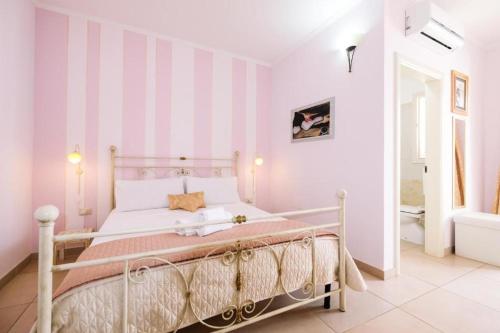 a white bedroom with a bed in a room at Adua Art in Castrignano del Capo