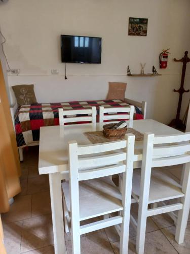 a living room with a table and chairs and a couch at Complejo Los Abuelos. in Norberto de la Riestra