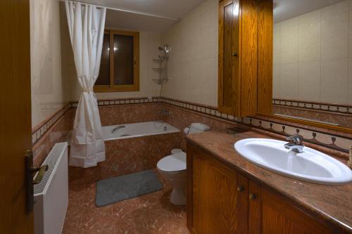 a bathroom with a sink and a tub and a toilet at Eidyllio ''The Mansion'' in Omodos