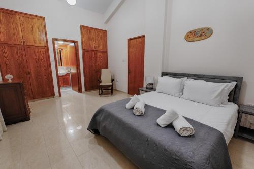 a bedroom with a large bed with towels on it at Eidyllio ''The Mansion'' in Omodos