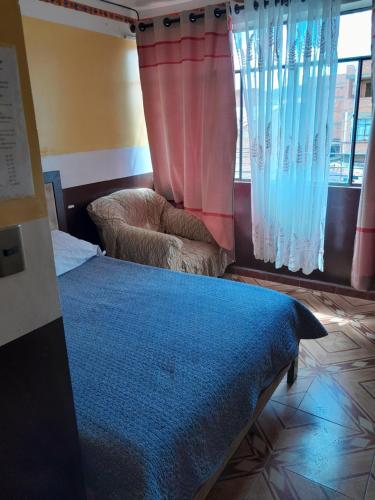 a bedroom with a bed and a window with curtains at Santa Fe in Oruro