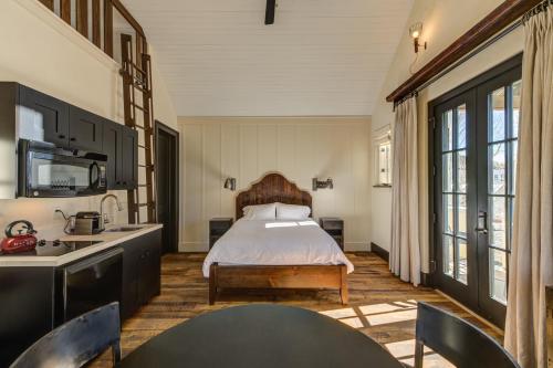 a bedroom with a bed and a kitchen at South Main Residences by Surf Hotel in Buena Vista