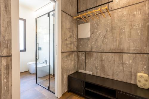 a bathroom with a wooden wall and a mirror at labotanica_casalounge in Cesenatico