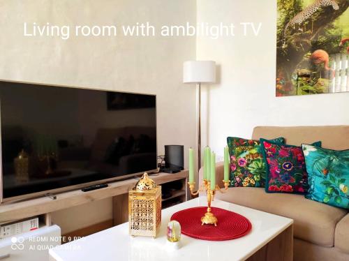 a living room with a living room with an umbrella tv at "Spirit of Malta" Historic Maltese Townhouse by the sea in Sliema