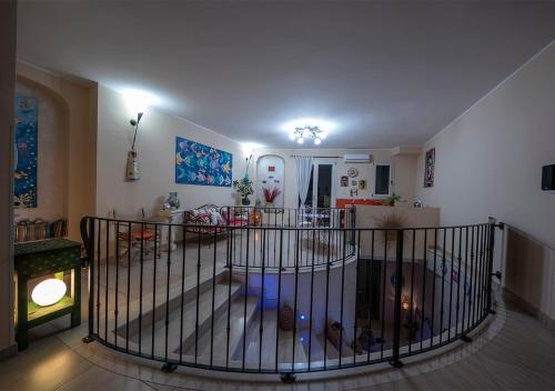 a living room with a spiral staircase in a house at Adua Art in Castrignano del Capo
