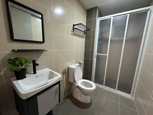 a bathroom with a toilet and a sink and a mirror at Sunset View at Modern Home in Kuala Lumpur
