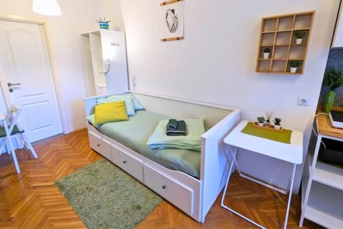 a bed in a room with a desk and a table at Cozy ensuite room in Zagreb center in Zagreb