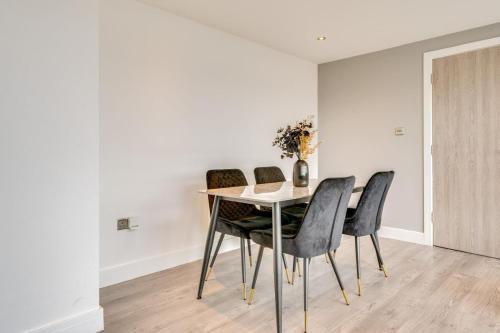a dining room with a table and chairs at ENTERPRISE APARTS in Bradford