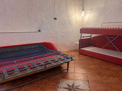 a red bunk bed in a room with a star on the floor at Olivetta House Holiday in Moneglia