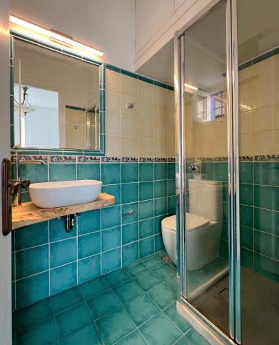 a bathroom with a tub and a sink and a toilet at Villa Sunset Signature - Private Pool & Sea View in Hydra