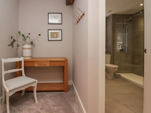 a bathroom with a desk and a toilet at Windermere in Kendal