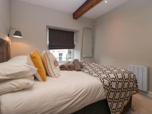 a bedroom with a bed with a teddy bear on it at Windermere in Kendal