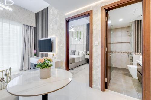 a living room with a table and a bathroom at GlobalStay Reva & Vera Residences Business Bay Apartments in Dubai