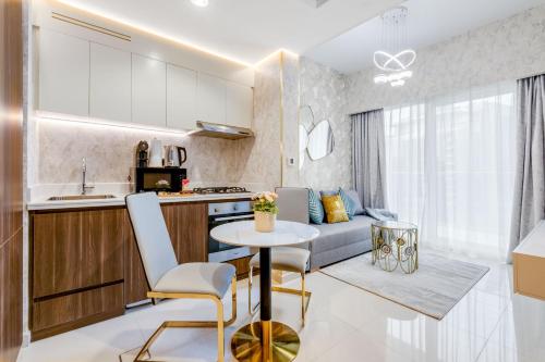 a kitchen and living room with a table and a couch at GlobalStay Reva & Vera Residences Business Bay Apartments in Dubai