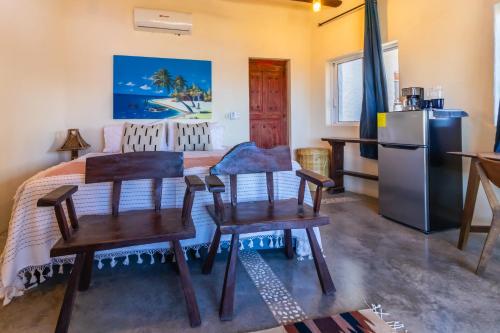 a kitchen with a table and chairs and a refrigerator at Pacific Villa Punta Mita-Playa Careyeros in Punta Mita