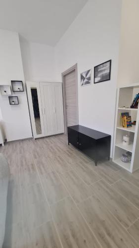 a room with a black table and a white wall at Via Contu in Iglesias