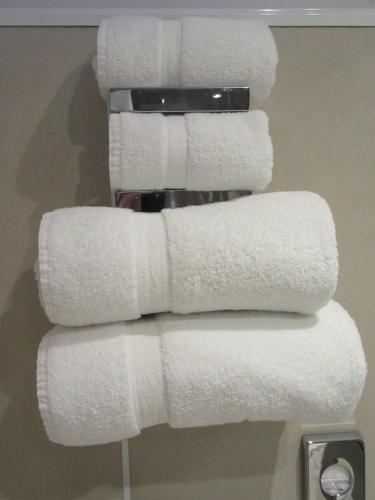 a stack of white towels on a rack in a bathroom at Sgurr Alasdair B&B in Portree