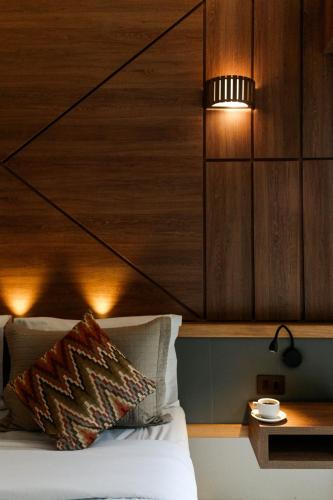 a bedroom with a bed with a wooden headboard at Pousada da Torre in Morro de São Paulo