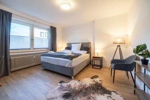 a bedroom with a bed and a large window at Cityapartment Wagner mit Netlix in Bielefeld