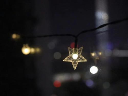 a christmas star is hanging from a wire at Mangrove Bay Riverside Hill Riverview B&Bl紅樹灣河畔山河景民宿l豪華五房六床高層山景河景l離華發商都商場和港珠澳大橋及拱北澳門關口10分鐘l離橫琴長隆王國25分鐘l樓下北山古城食街 in Zhuhai