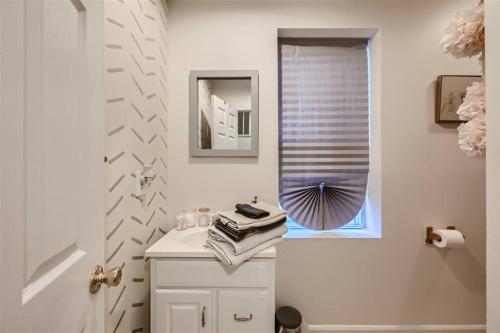 a white bathroom with a sink and a mirror at Baltimore Beauty! Johns Hopkins! 3 bedroom apt in Baltimore