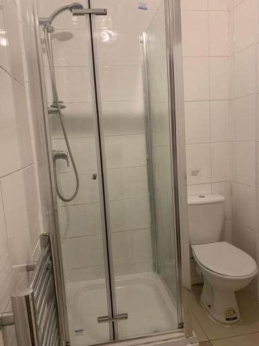 a bathroom with a shower and a toilet at City Lodge London in London